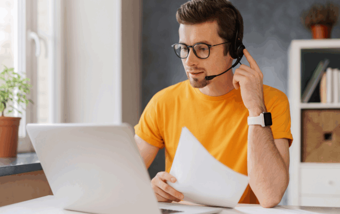 UCaaS Solutions, man working with a headset at a laptop